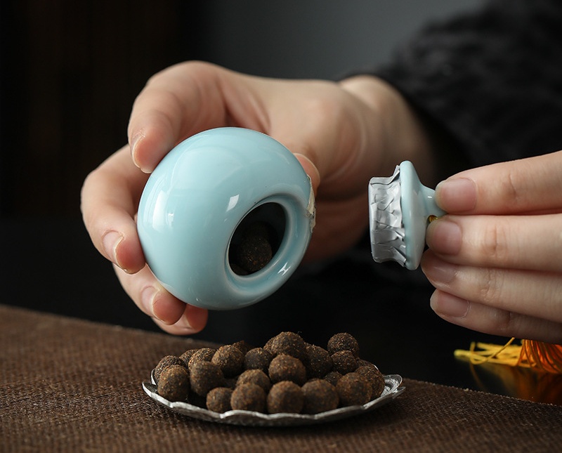Hand pouring incense pellets from ceramic jar &ndash; showing natural texture of hand-rolled honey incense