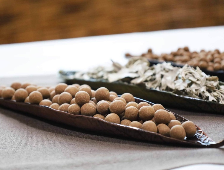 A boat-shaped tray filled with handmade white sage incense pellets for natural home fragrance and air purification.